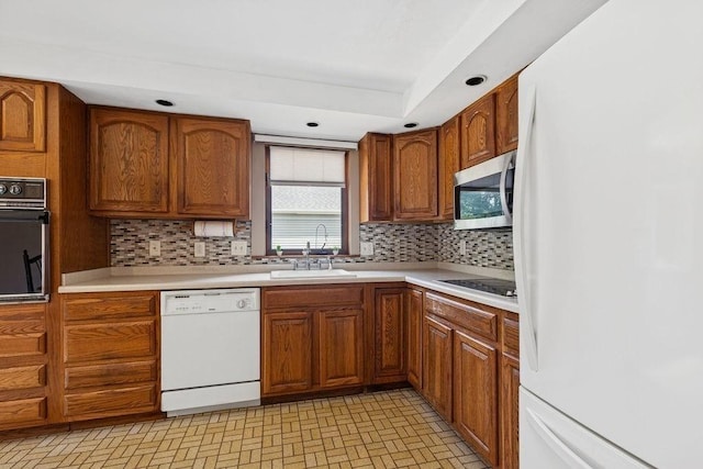 32 Cambo St, Brockton, MA 02301 - kitchen with black appliances, brown cabinetry, backsplash, light countertops, and recessed lighting