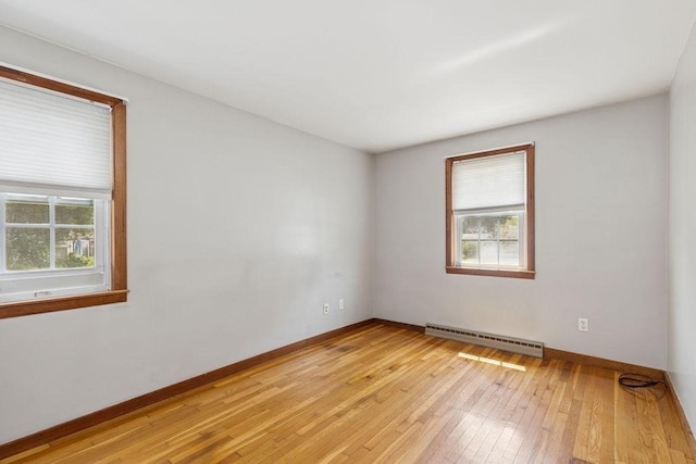 32 Cambo St, Brockton, MA 02301 - empty room with a baseboard heating unit, healthy amount of natural light, and light wood finished floors