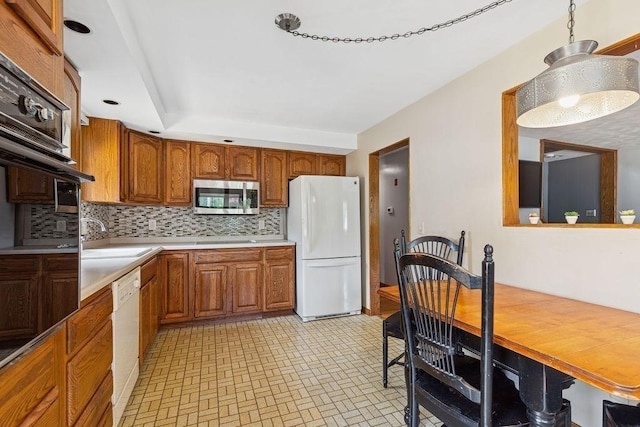 32 Cambo St, Brockton, MA 02301 - kitchen with white appliances, brown cabinetry, decorative backsplash, and light countertops