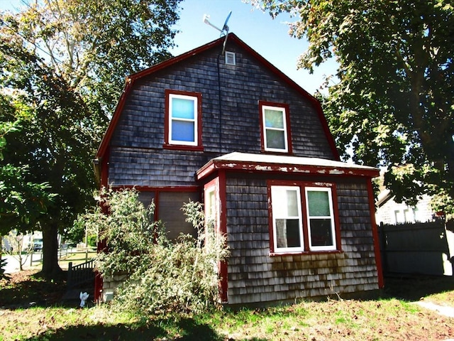 14 Park Pl, Harwich, MA 02646 - view of side of property with a gambrel roof and fence