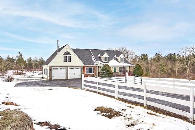 new england style home featuring a garage