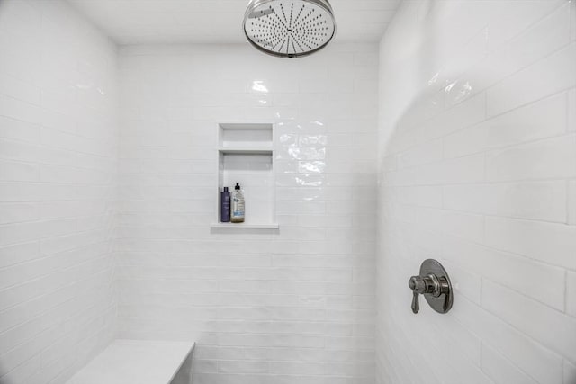 bathroom with a tile shower