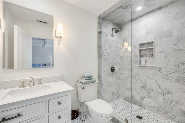 bathroom with toilet, vanity, a marble finish shower, and visible vents