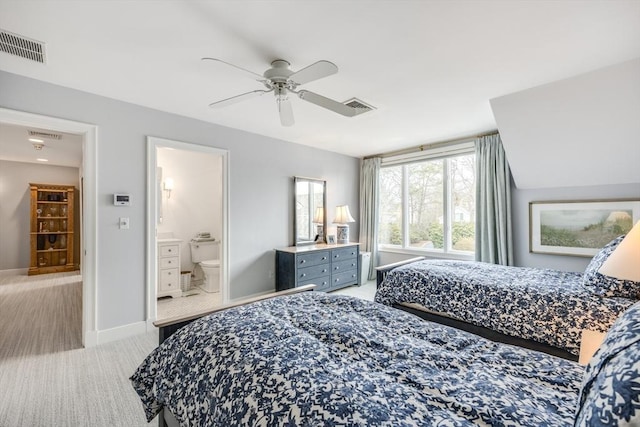 bedroom with light carpet, ensuite bathroom, visible vents, and baseboards