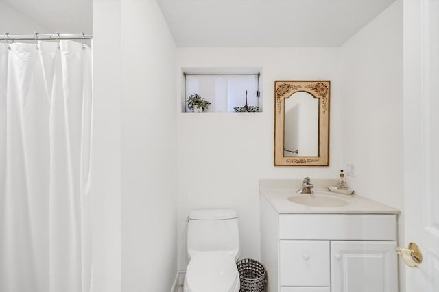 full bath with curtained shower, vanity, and toilet