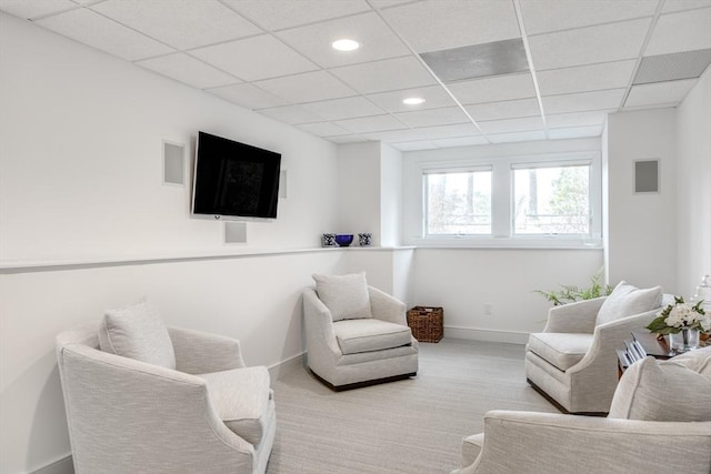 living area featuring a paneled ceiling, recessed lighting, carpet floors, visible vents, and baseboards