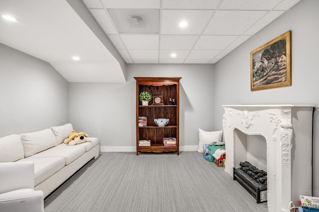 carpeted living area with recessed lighting, a paneled ceiling, and baseboards