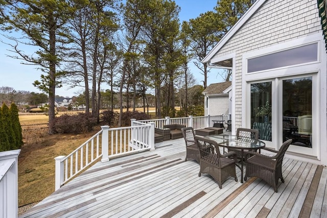 deck with outdoor dining area