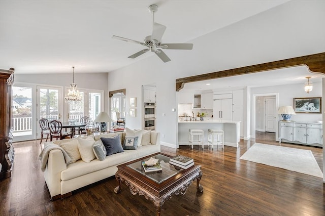 living area featuring dark wood-type flooring, lofted ceiling, baseboards, and ceiling fan with notable chandelier