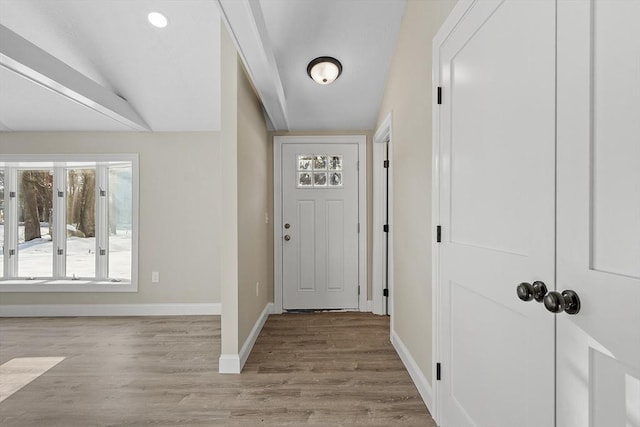 entryway with recessed lighting, lofted ceiling, baseboards, and wood finished floors