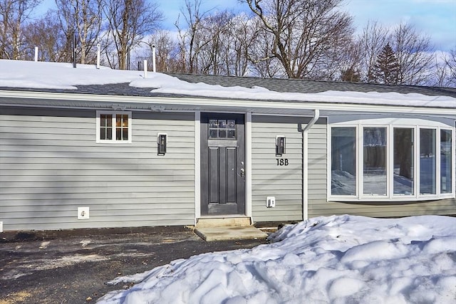 view of snow covered property entrance