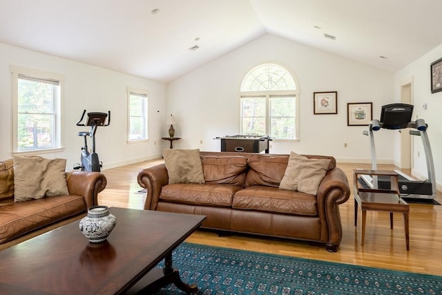 living room with light hardwood / wood-style flooring and lofted ceiling