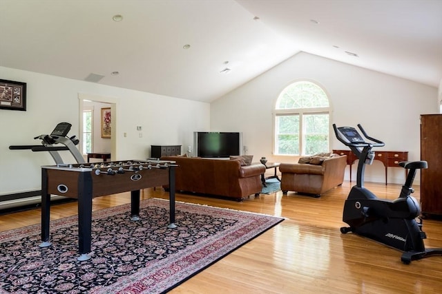 game room with light hardwood / wood-style flooring and lofted ceiling