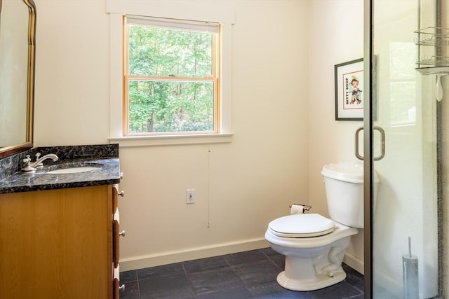 bathroom with walk in shower, vanity, toilet, and plenty of natural light