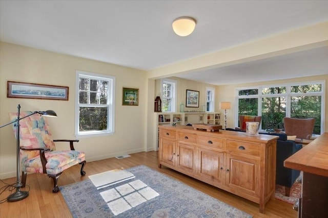 sitting room featuring light wood-style floors, baseboards, and visible vents