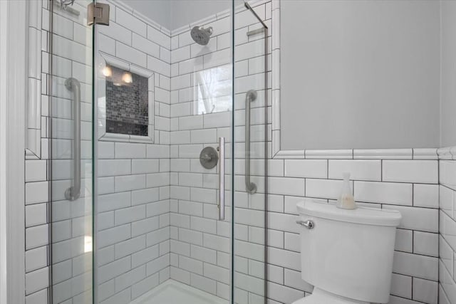 bathroom with toilet and a shower stall