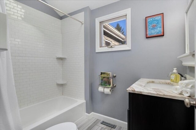 full bathroom featuring visible vents, baseboards, vanity, toilet, and shower / tub combo with curtain