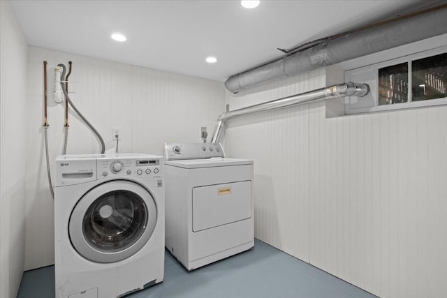 clothes washing area with separate washer and dryer and recessed lighting