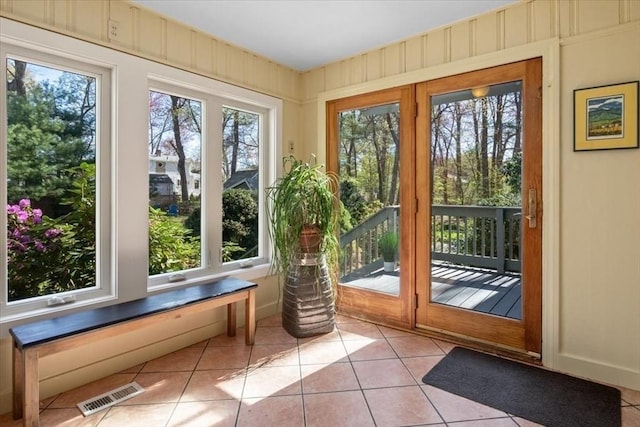 doorway to outside featuring light tile patterned flooring and visible vents