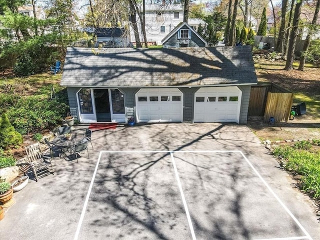 garage featuring aphalt driveway