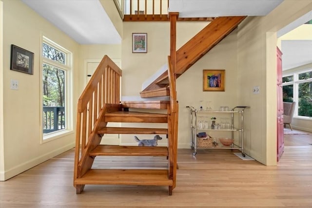 stairway featuring baseboards and wood finished floors
