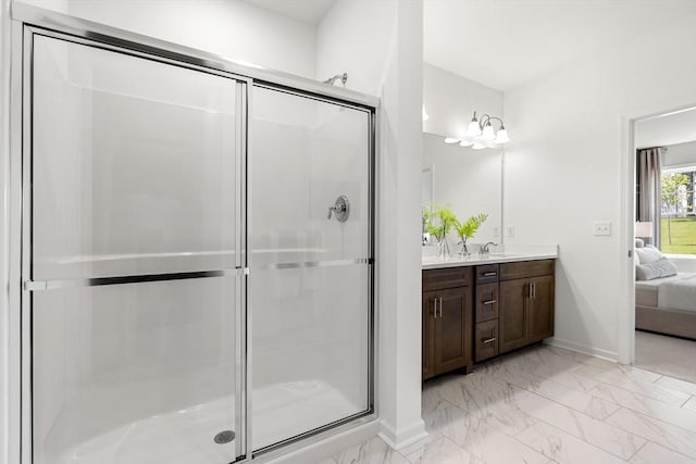 320 Martins Lndg Unit 307, North Reading, MA 01864 - bathroom with ensuite bathroom, marble look tiles, a stall shower, and vanity