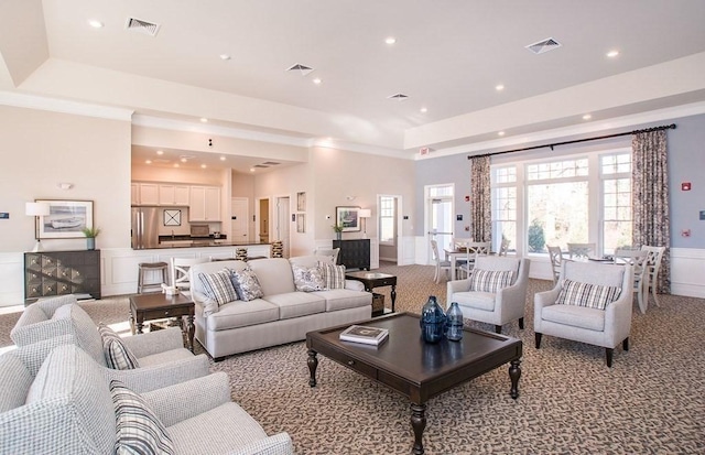 320 Martins Lndg Unit 307, North Reading, MA 01864 - living room featuring a tray ceiling, light colored carpet, recessed lighting, wainscoting, and ornamental molding