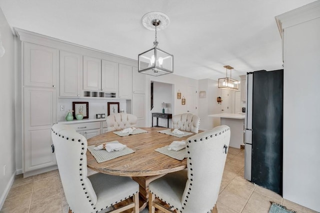 tiled dining space featuring a notable chandelier