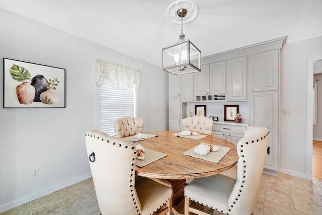 dining area featuring light tile patterned floors and a chandelier