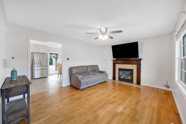 living room featuring light hardwood / wood-style flooring and ceiling fan