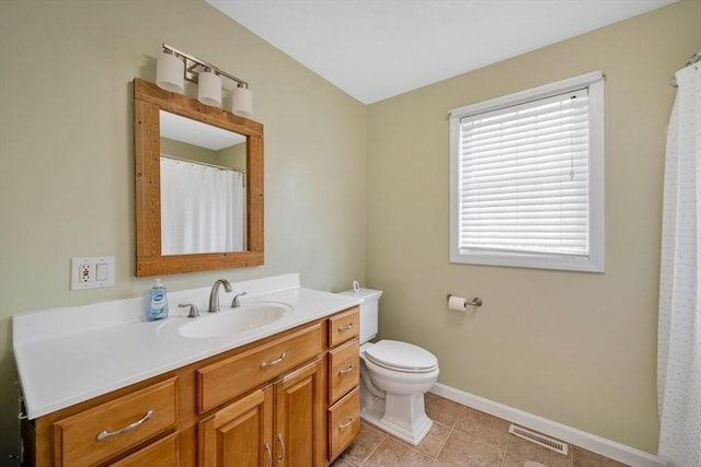 bathroom featuring vanity, tile patterned flooring, and toilet