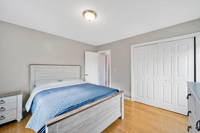 bedroom with a closet and light hardwood / wood-style flooring