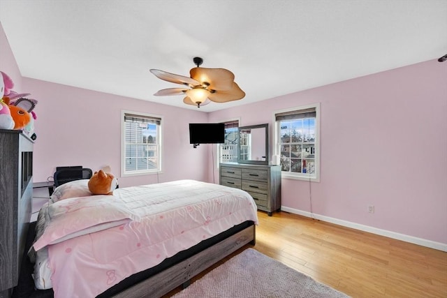 bedroom with ceiling fan and light hardwood / wood-style floors