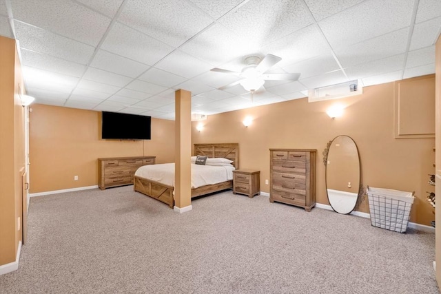 unfurnished bedroom with carpet, a paneled ceiling, and ceiling fan