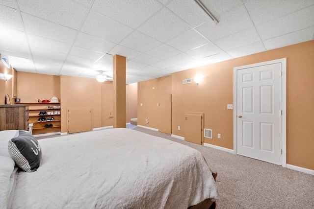 carpeted bedroom with a paneled ceiling