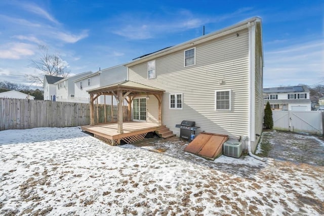 snow covered property with a gazebo, a deck, and central AC