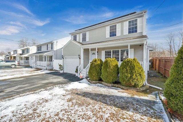 front of property with a porch and a garage