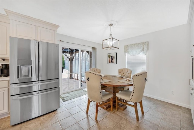 tiled dining area with a notable chandelier