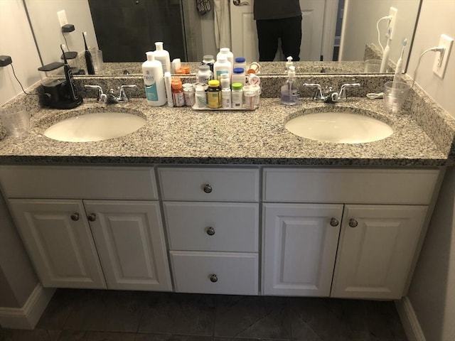 full bath with double vanity and a sink