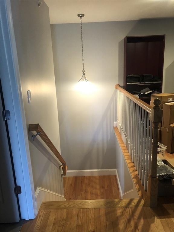 stairs featuring baseboards and wood finished floors