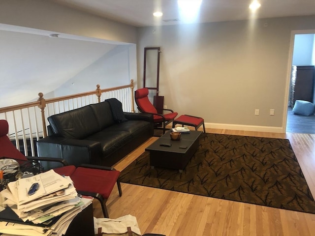 living area with baseboard heating, baseboards, recessed lighting, and wood finished floors