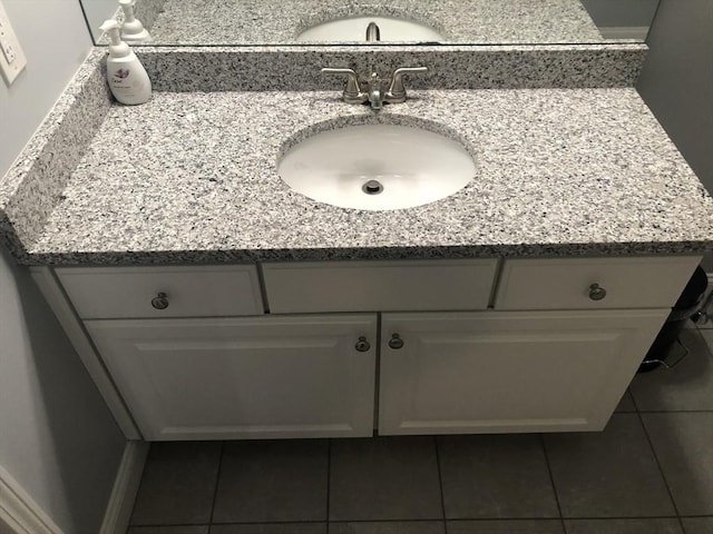 bathroom with tile patterned flooring and vanity
