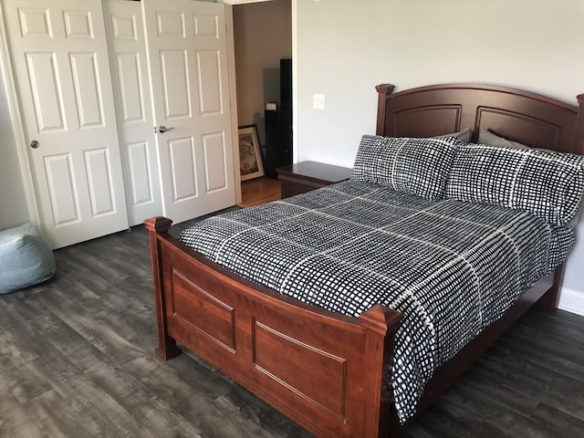 bedroom featuring a closet and dark wood-style floors