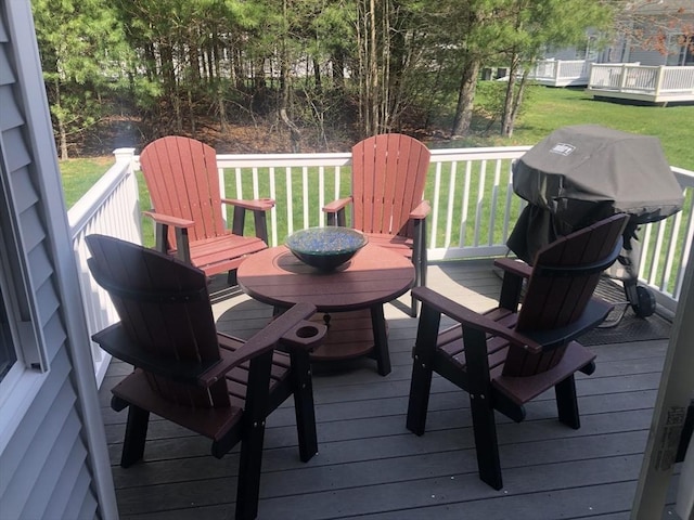 wooden deck with a lawn
