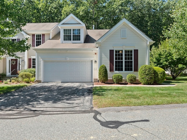 view of front of house with a garage and a front lawn