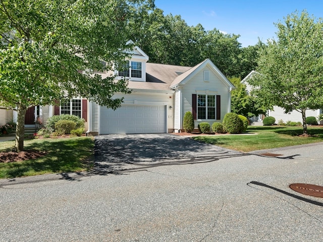 cape cod-style house with a front yard and a garage