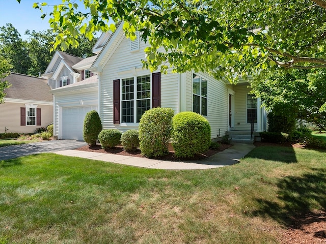 view of front of property with a front yard and a garage