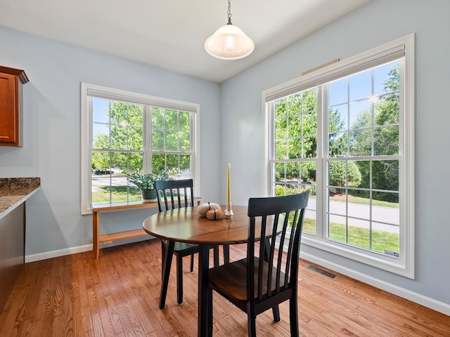 dining space with light hardwood / wood-style floors