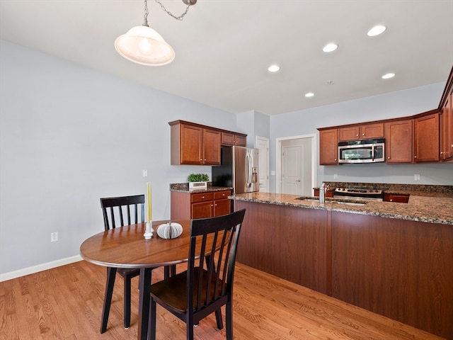 dining room with light hardwood / wood-style flooring and sink