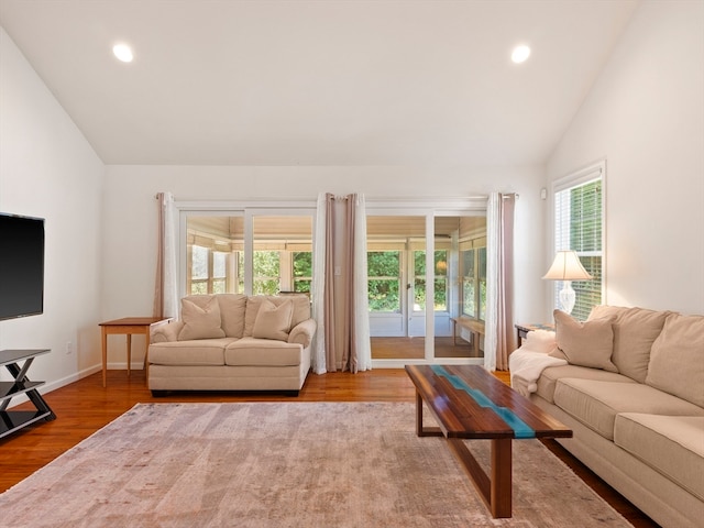 living room featuring french doors, hardwood / wood-style flooring, and vaulted ceiling